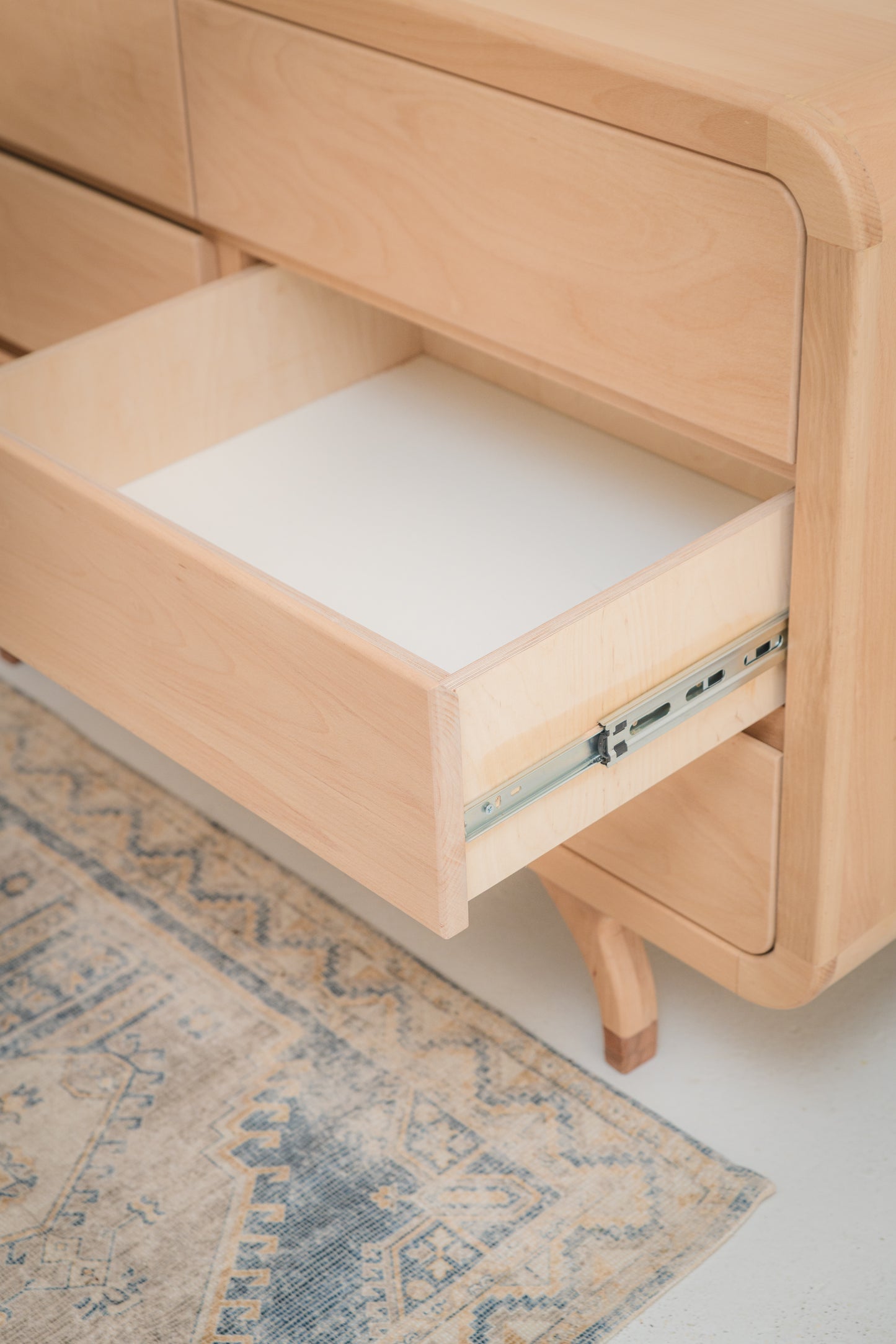 Handcrafted Love Local Niki hardwood compactum made from natural Beechwood, featuring six soft-close drawers and curved edges for a warm, elegant nursery aesthetic.