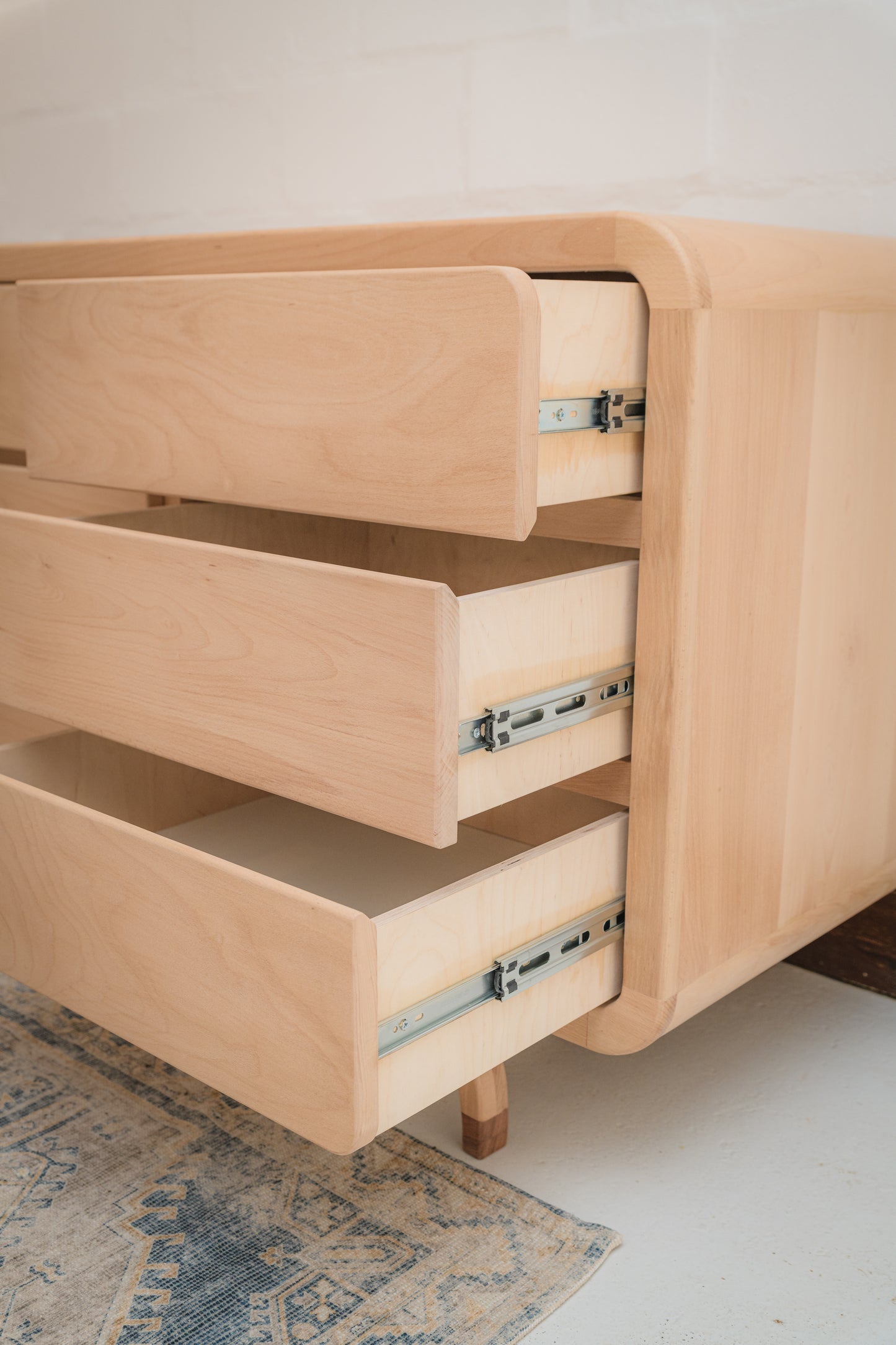 Handcrafted Love Local Niki hardwood compactum made from natural Beechwood, featuring six soft-close drawers and curved edges for a warm, elegant nursery aesthetic.